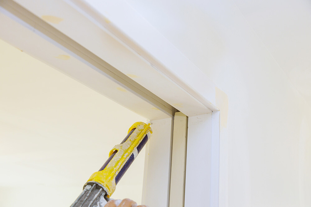 sealing a door with caulk to prevent water damage